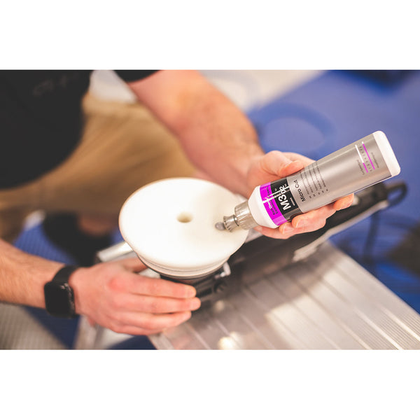 Koch Chemie Micro Cut 250ml bottle pouring product onto a polishing pad.
