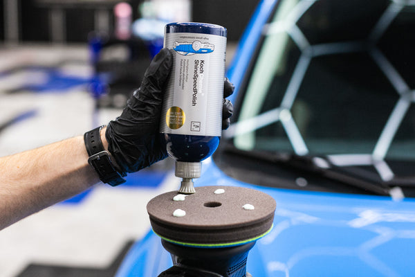 A person adding Koch Chemie Shine Speed Polish to a Koch Chemie Polish and Sealing Pad.