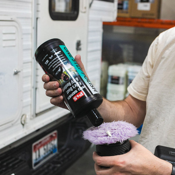 A person pouring Kyle's Boat and RV Restorer on a purple brush.
