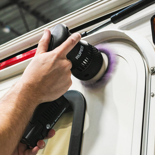 A person polishing an RV door with the P & S Kyle's Boat and RV Restorer.