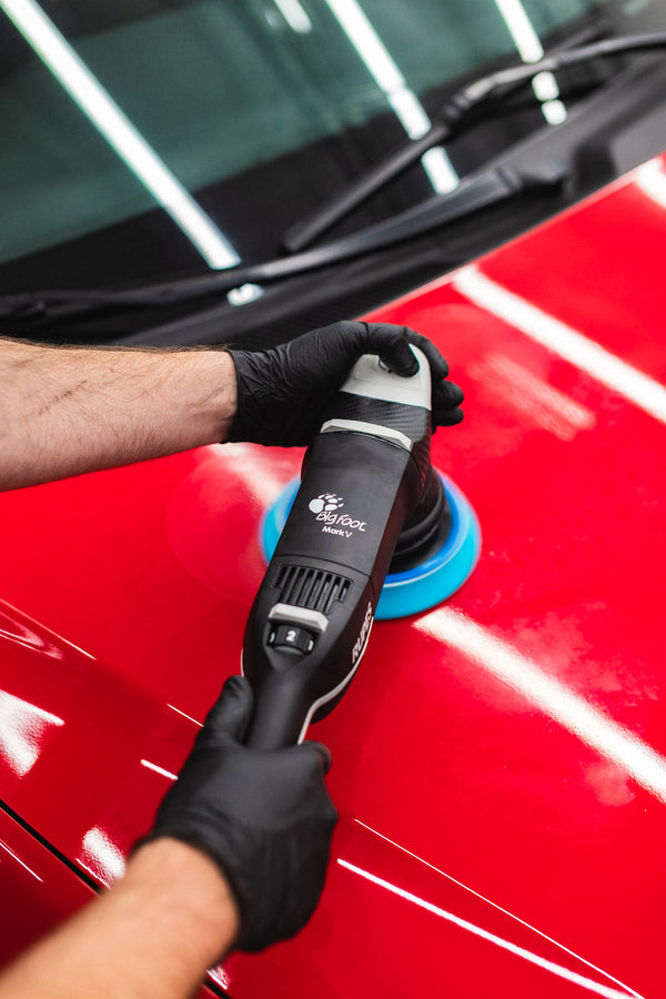 Rupes LHR Mark V polishing the hood of a vehicle.