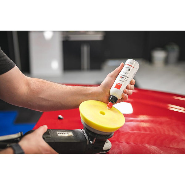 Rupes Uno Protect 250ml pouring on a polishing pad.