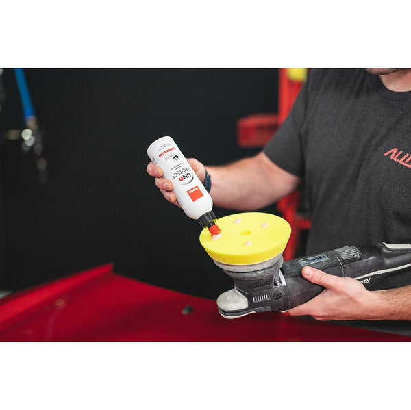 Rupes Uno Protect 250ml pouring product on a polishing pad.