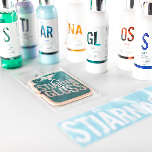 The entire contents of the Stjarnagloss - Essential Gift Box, which includes Bubblor high gloss car wash - 100ml, Skära gloss-enhancing polish - 100ml, Gummi trim and tyre dressing - 100ml, Tjära tar and bug remover - 100ml, Glas professional glass cleaner - 100ml, Pärla spray sealant - 100ml, Silke high gloss detailing spray - 100ml, Stjärnagloss air freshener, and Stjärnagloss vinyl sticker