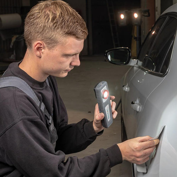A person using the Sunmatch 3 to illuminate the side of their car.