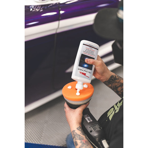 A closeup of a person pouring TLD The Final Polish on a polisher.