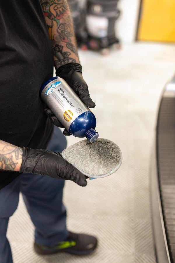 A person adding a Koch Chemie Cleaner to a TRC Ultra No Soak Round Detailing Applicator.