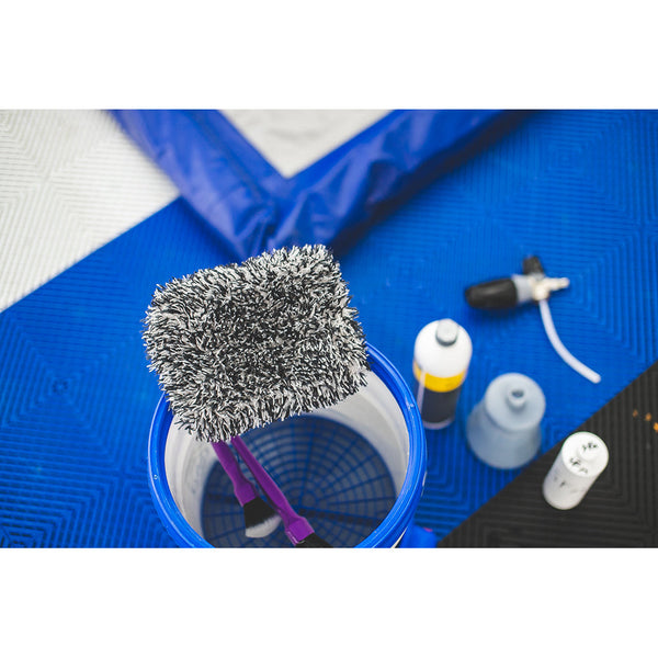 White and black TRC microfiber wash pad in a bucket surrounded by rinse less wash tools