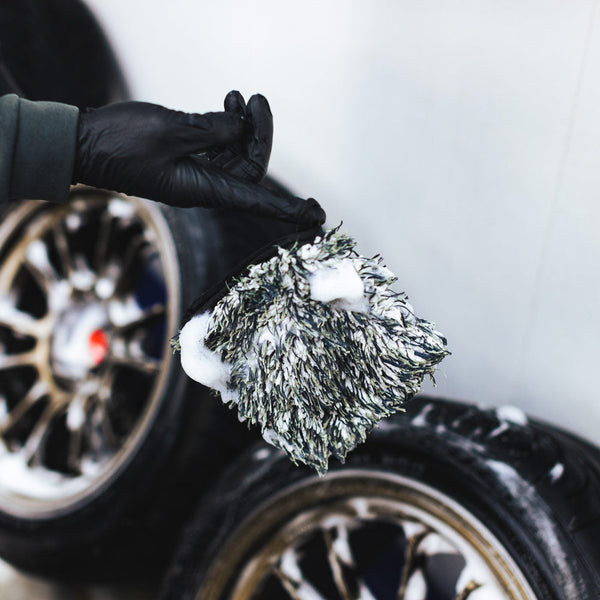 Wheel Mitt being used to clean a tire wheel