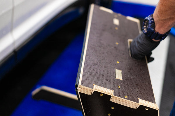 A close up of someone grabbing the Wrap Step by the handle to move it.