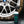 A spray bottle of Armour Tire Cleaner in front of a dirty tire.