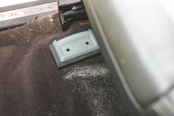 A Detail Factory Pet Hair Card laying next to a pile of pet hair that it cleaned.