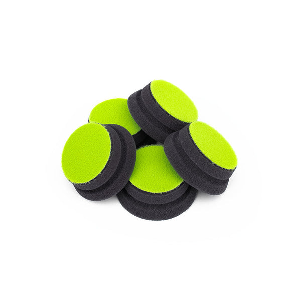 A pile of five green Koch Chemie polish pads on a white background.
