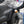 A person spraying Koch Chemie Protector Wax onto a grey Toyota Tacoma .