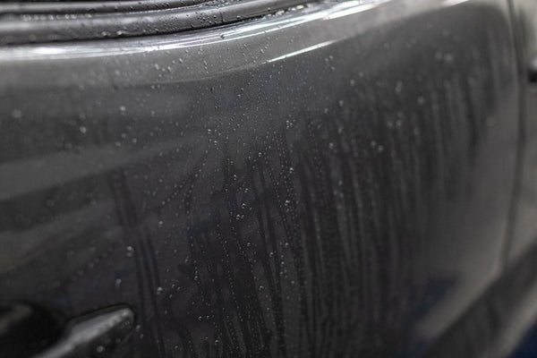 Grey Toyota Tacoma with Koch Chemie Protector Wax applied, showcasing water droplets not sticking to the surface of the vehicle.